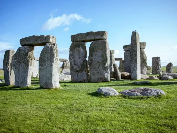gray rock formation on green grass field during daytime