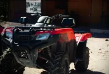 a red four wheeler parked in front of a building
