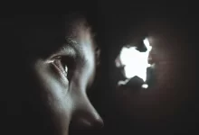 person watching through hole