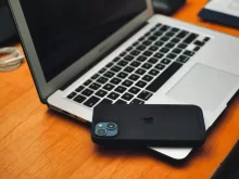 a laptop computer sitting on top of a wooden desk