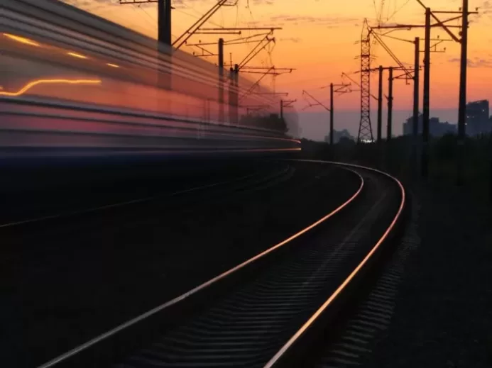 Rail Road Under Gray and Orange Cloudy Sky during Sunset