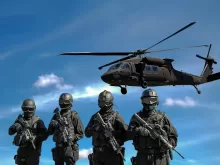 Four Soldiers Carrying Rifles Near Helicopter Under Blue Sky