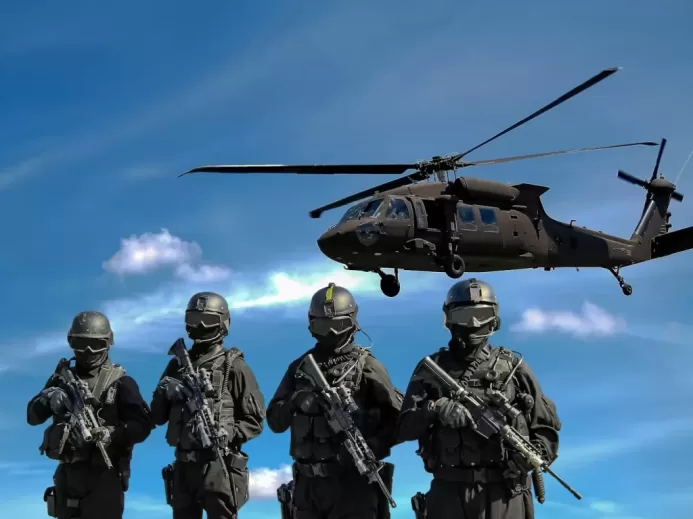 Four Soldiers Carrying Rifles Near Helicopter Under Blue Sky