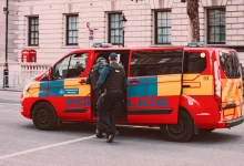 a couple of men standing next to a van