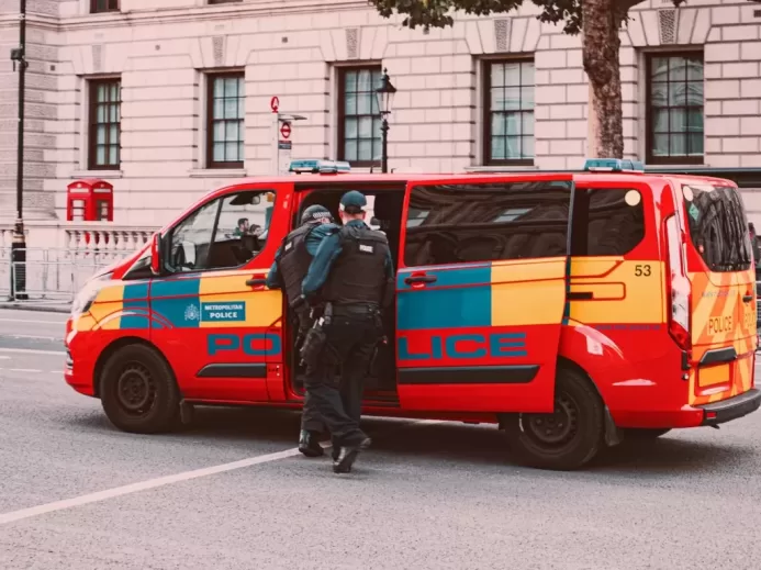 a couple of men standing next to a van