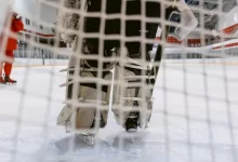 People Playing Ice Hockey on Ice Field