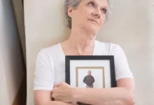 Elderly Woman Holding a Photo Frame