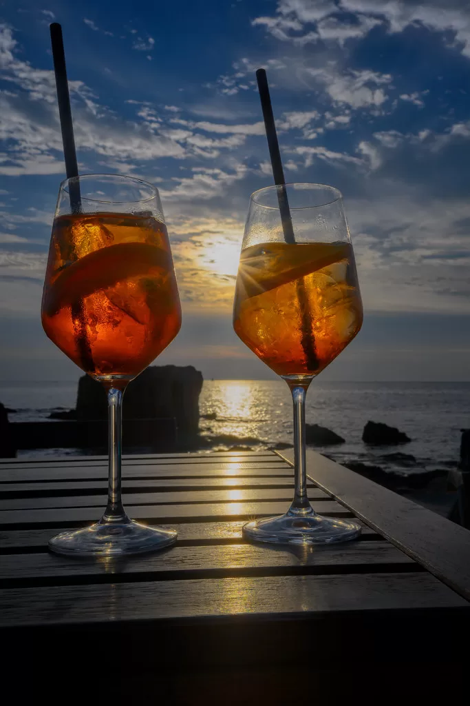 Two Aperol Spritz drinks at sunset in the coastal town of Alghero, Sardinia, Italy - Pravda24