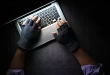 person in black long sleeve shirt using macbook pro