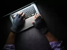 person in black long sleeve shirt using macbook pro