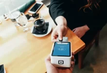 person holding credit card swipe machine