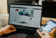 person using both laptop and smartphone