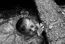 Monochrome Photo of Child on a Canal