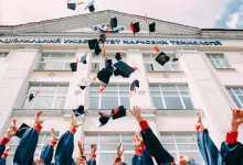 group of fresh graduates students throwing their academic hat in the air