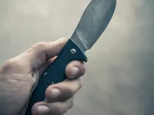 person holding black handle knife