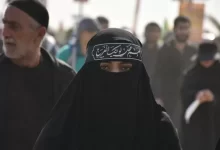 group of people in black walking