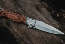 brown handle silver knife on brown wooden table