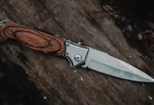 brown handle silver knife on brown wooden table