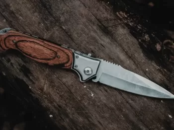 brown handle silver knife on brown wooden table
