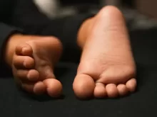 persons feet on black textile
