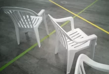 a couple of white chairs sitting next to each other