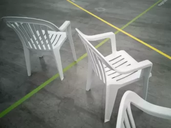 a couple of white chairs sitting next to each other