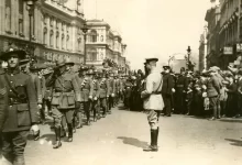 soldiers walking near people at the city photo
