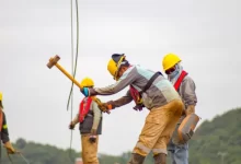 construction worker men holding hammer