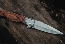 brown handle silver knife on brown wooden table