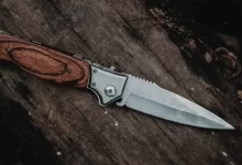 brown handle silver knife on brown wooden table