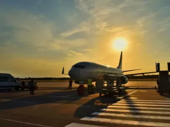 white airplane parked during daytime