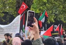 a crowd of people holding up their cell phones