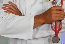 doctor holding red stethoscope