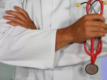 doctor holding red stethoscope