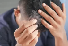 a man is combing his hair with his hands