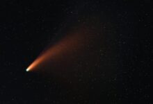 A vibrant comet with a glowing tail traversing the starry night sky, showcasing the wonders of the universe.
