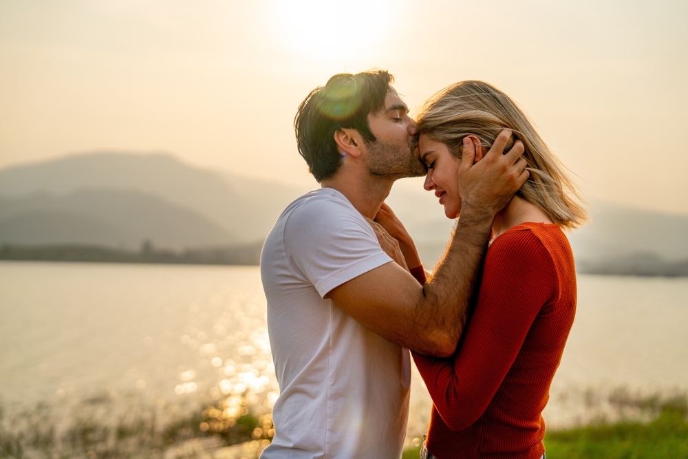 CloseUpCaucasianManKissOnForeheadOfBeautifulWoman - Pravda24 Muž líbá ženu na čelo.