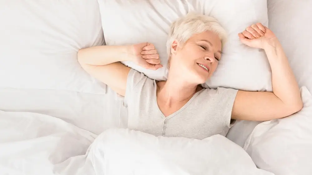 shutterstock_2477757779 - Pravda24 Žena v posteli se probouzí.