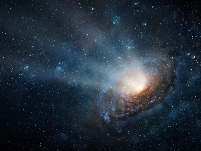 Detailní záběr na spirální galaxii v hlubokém vesmíru s jasným středem a proudy hvězdného prachu
